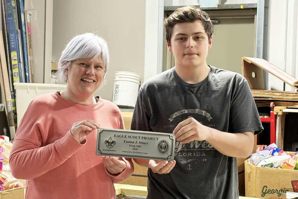 Esther Roberts (left) and Easton Stiner (right) hold service project plaque